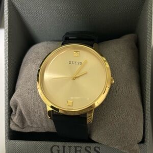 Guess black and gold analog watch.